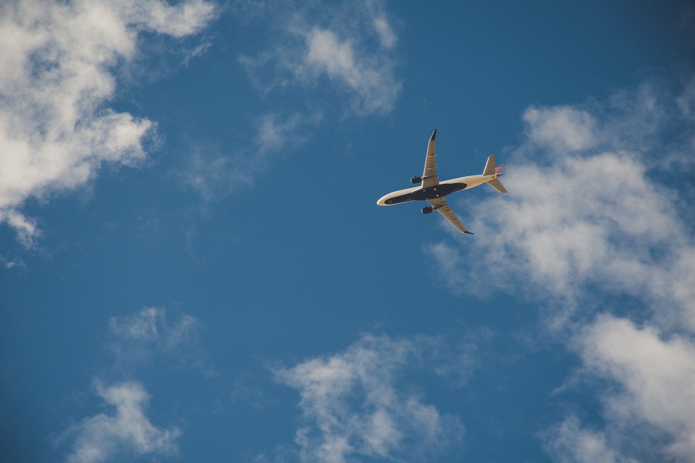 Worms Eye View of Airplane Flying on Sky